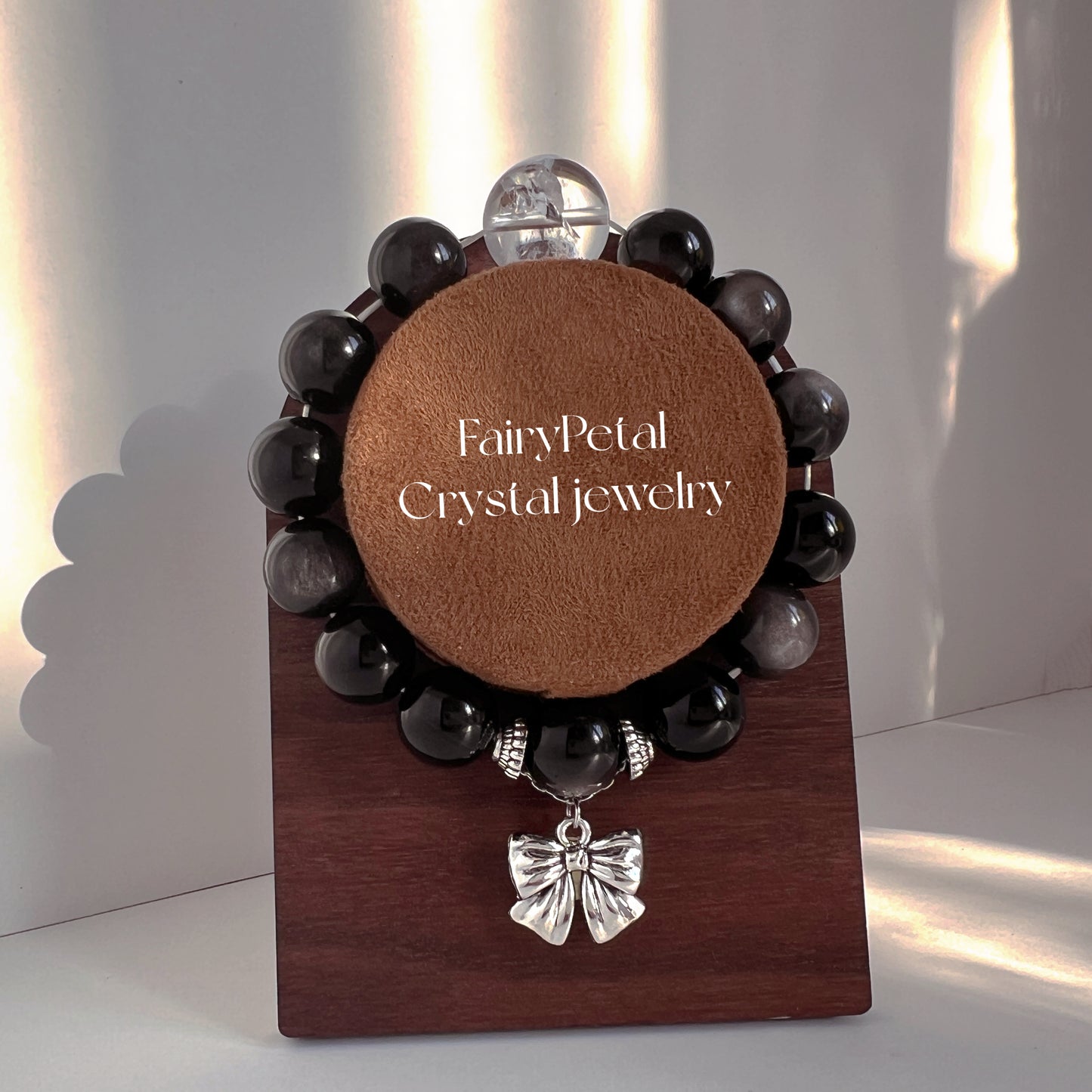 Originally designed silver obsidian beaded bracelet with big bow and white Arce crystal.