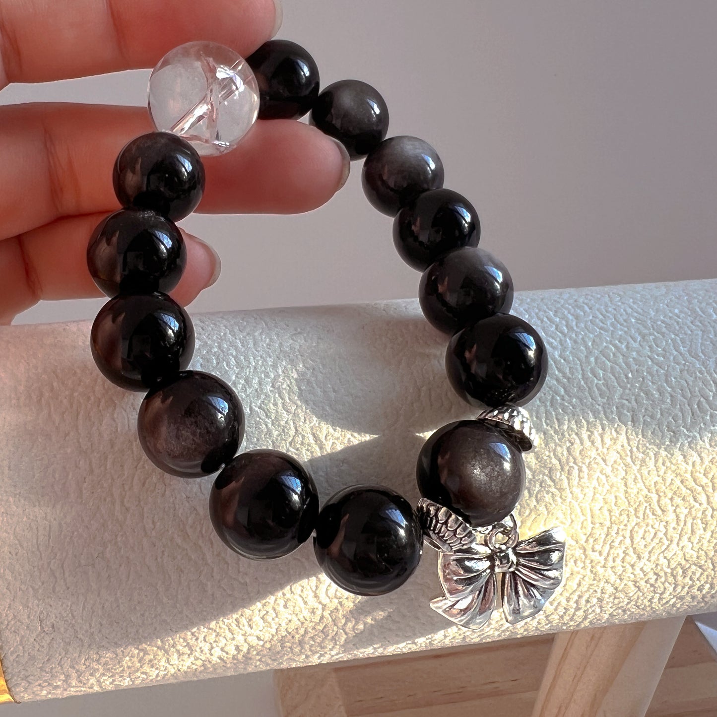 Originally designed silver obsidian beaded bracelet with big bow and white Arce crystal.