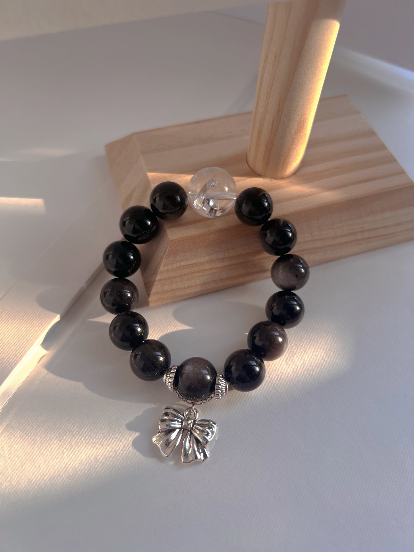 Originally designed silver obsidian beaded bracelet with big bow and white Arce crystal.